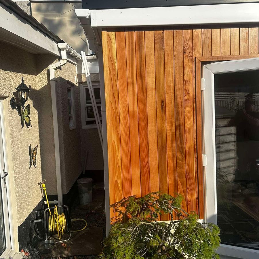 Cedar-clad extension beside the house