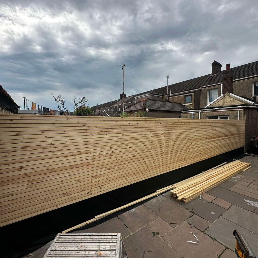 Long run of new slatted fencing