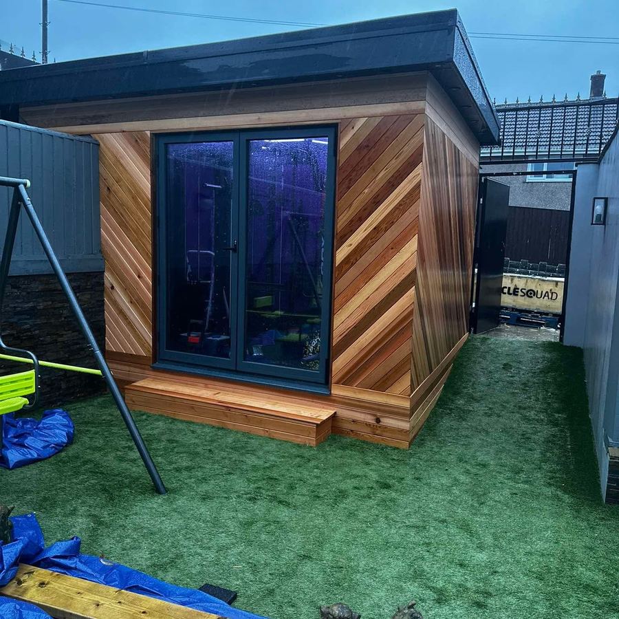 Garden room with diagonal cedar cladding and grey doors